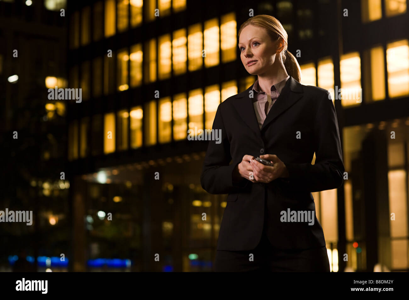 Geschäftsfrau vor eine beleuchtete Gebäude Stockfoto