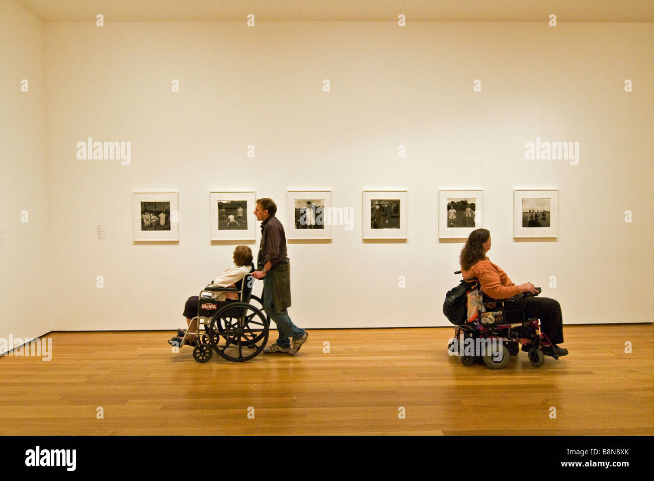 Besucher im Rollstuhl anzeigen eine Ausstellung im Museum für moderne Kunst Stockfoto