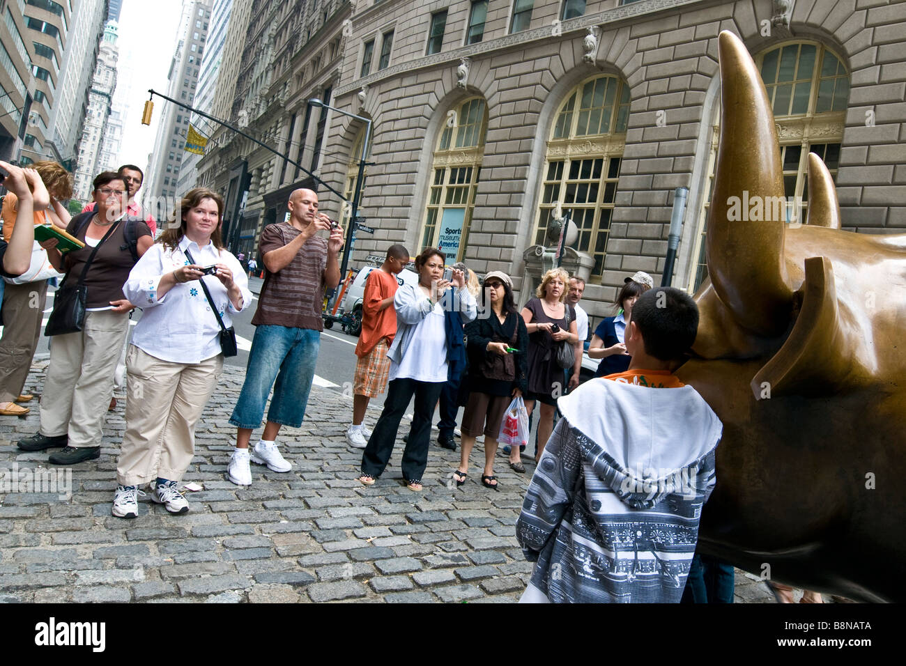 Touristen fotografieren die Bronze Stier laden im Zentrum von New York City Stockfoto