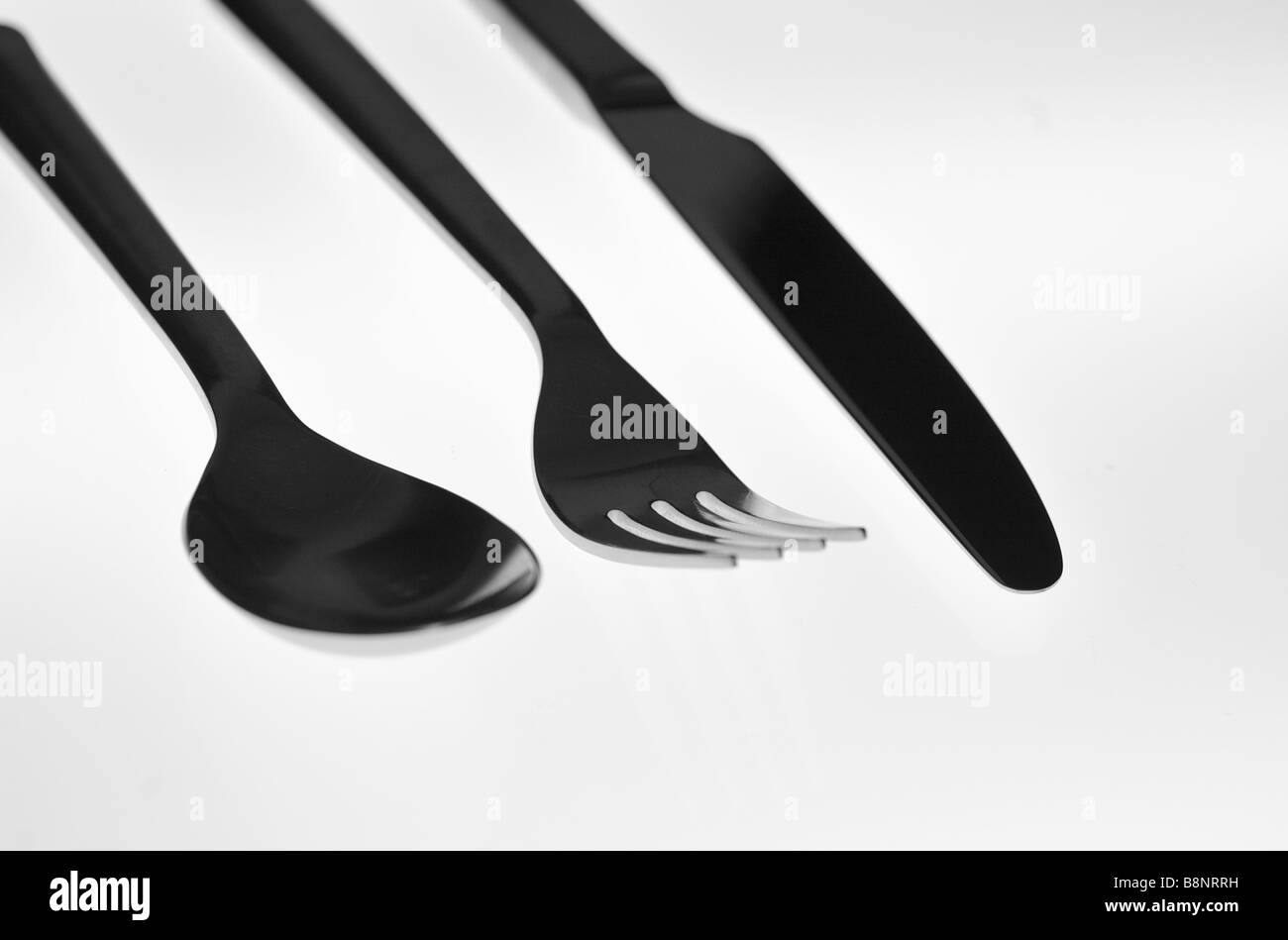 Lebendige Silhouette Bild von Essgeschirr (Löffel, Gabel und Messer) mit weißem Hintergrund Stockfoto