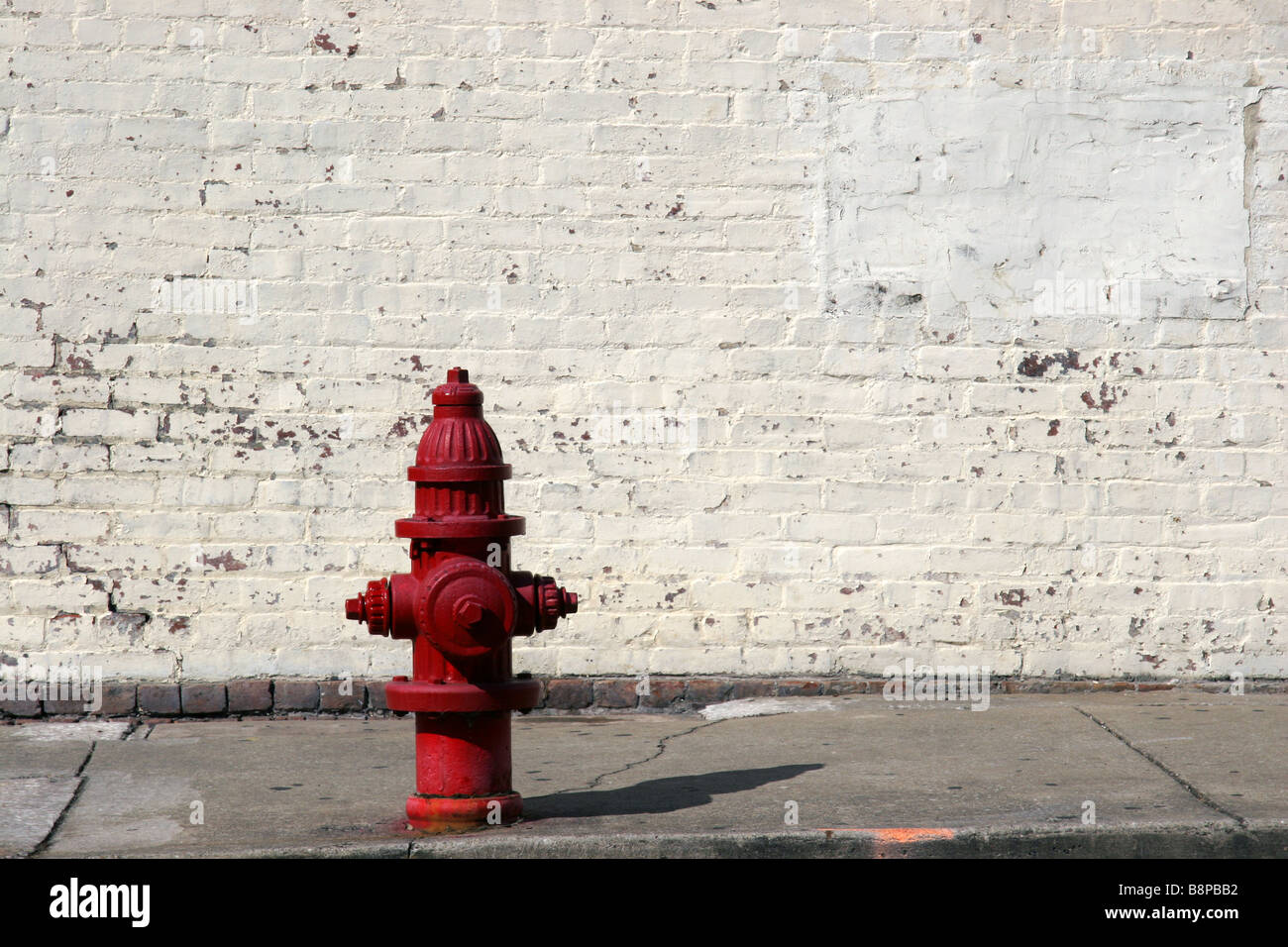Amerikanischen roten Hydranten und weiße Mauer Stockfoto