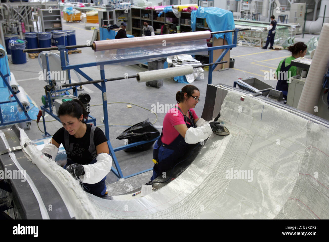 Arbeitnehmer neben einer riesigen Wind Turbinenschaufel in der Fabrik VentoMoinho in Viana Castelo, Portugal. Stockfoto