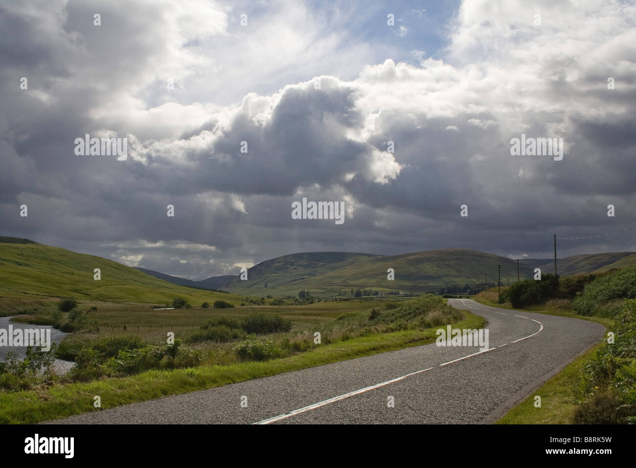 Straße nach St. Mary s Loch mit dem Fluss Schafgarbe im Vordergrund in den Scottish Borders Stockfoto