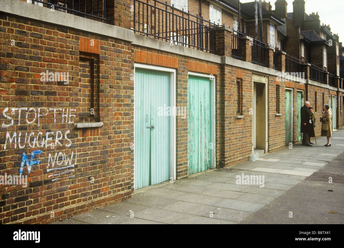 Straße der Rat Häuser in Süd-London mit Warnung an Straßenräuber an einer Wand Stockfoto