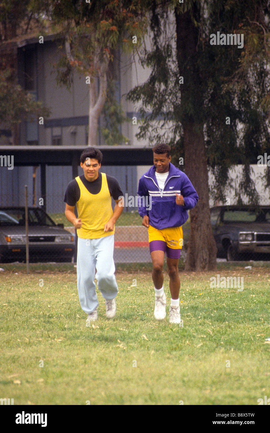 Hispanische College University Student Mann schwarz Freund Jog Athetic Feld Schule Vortrag Anteil fördern Tempo Stockfoto