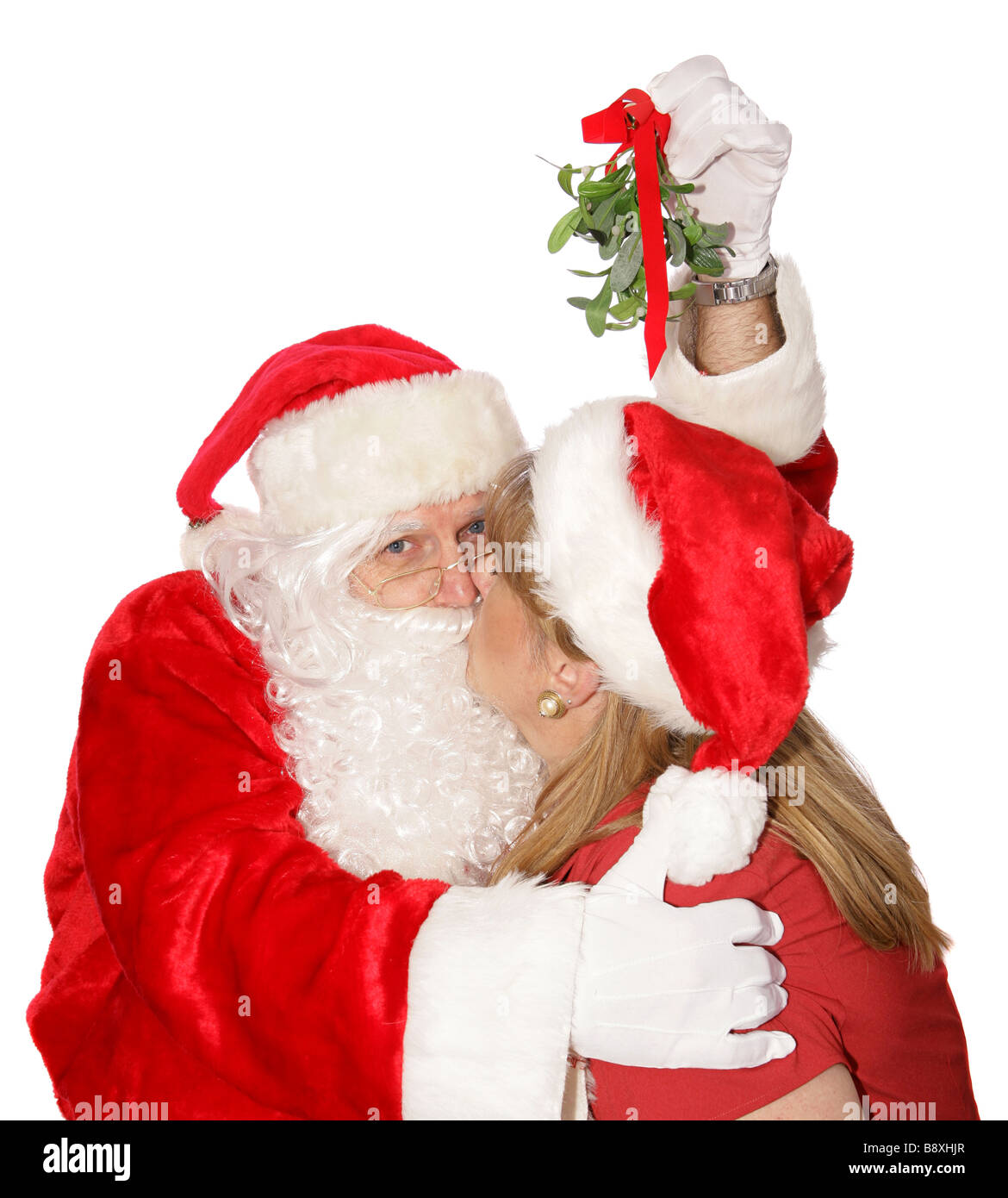 Santa ist einen Kuss unter dem Mistelzweig immer bei der Weihnachtsfeier am Nordpol Stockfoto