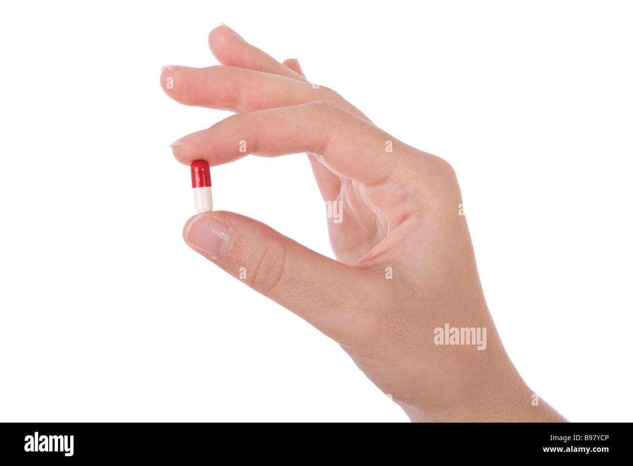 Hand, die eine Kapsel oder Pille isoliert auf weiss Stockfoto
