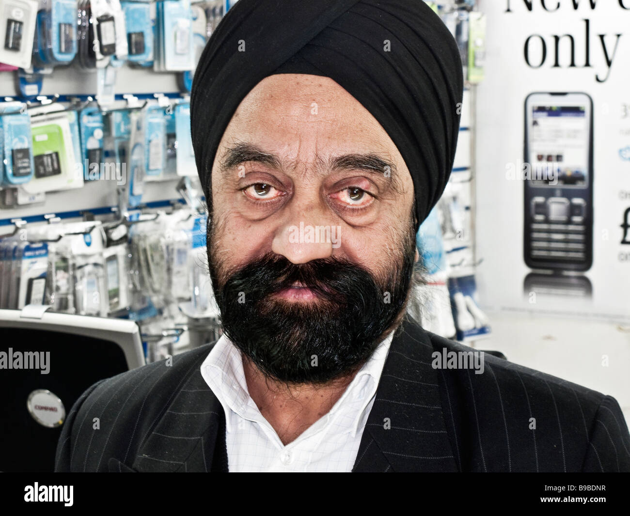 Sikh Mann im Handy-Shop London England Stockfoto