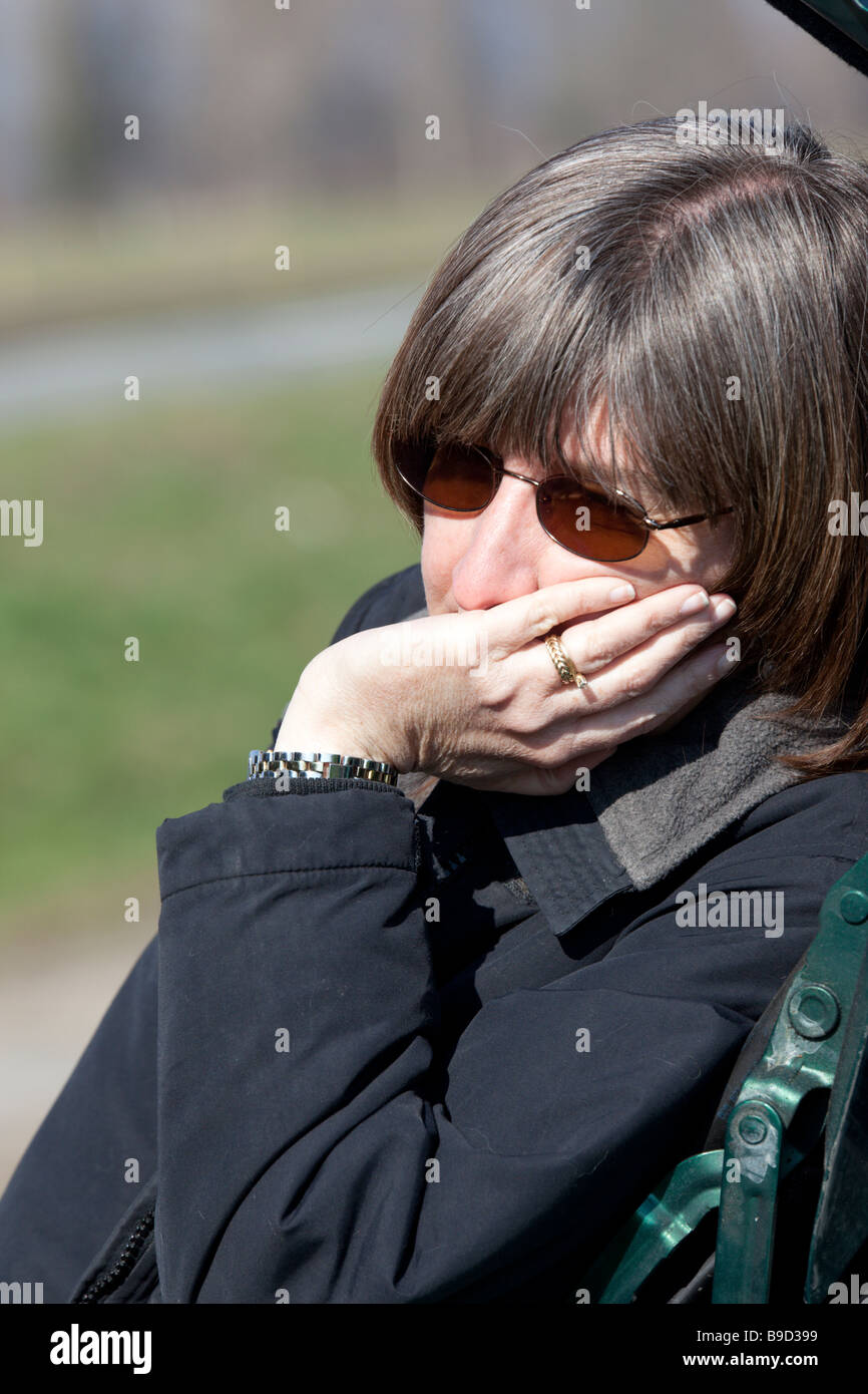 Gelangweilt, Vergrauung mittlere gealterte Frau stützte sich auf ihre hand Stockfoto
