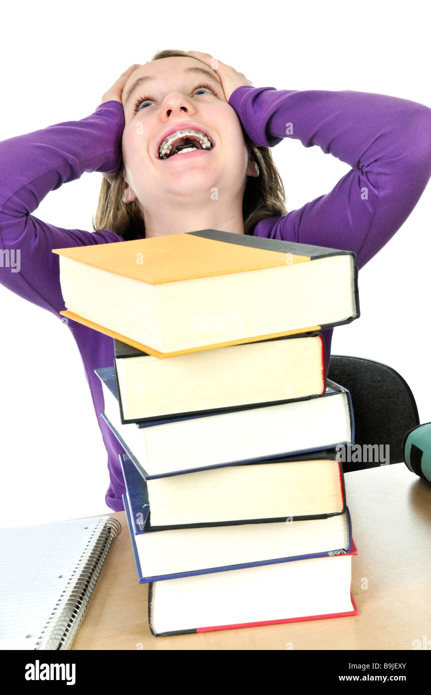 Frustriert Teenager-Mädchen studiert an der Rezeption mit großen Stapel Bücher Stockfoto