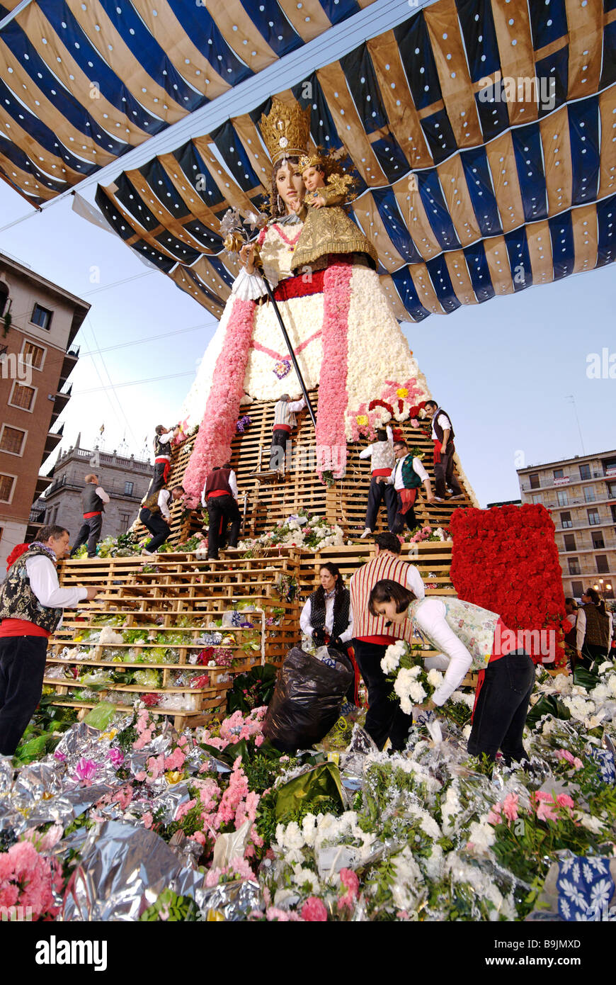 Männer, die große hölzerne Replik Statue der Virgen de Los Desamparados Blume Angebote Inverkehrbringen. Las Fallas Festival Valencia, Spanien Stockfoto