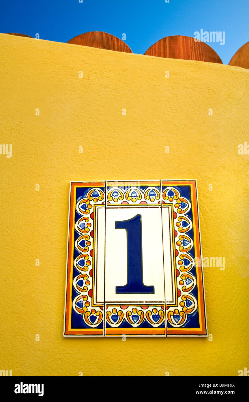 Nummer eins Villa Wand Fliesen Keramik dekorative Fliesen 'Nummer 1' auf der gelben Wand außerhalb Sunny Holiday Vacation Resort mediterrane Villa Apartment Stockfoto