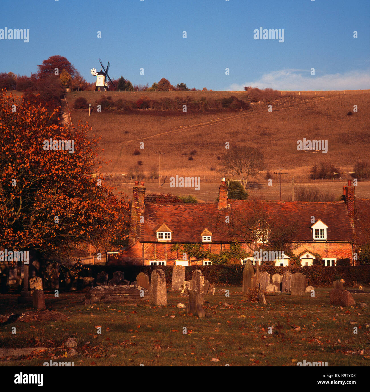 Häuserzeile in Turville Dorf mit Windmühle auf Hügel im Hintergrund, Chiltern Hills, Buckinghamshire, Herbst Stockfoto