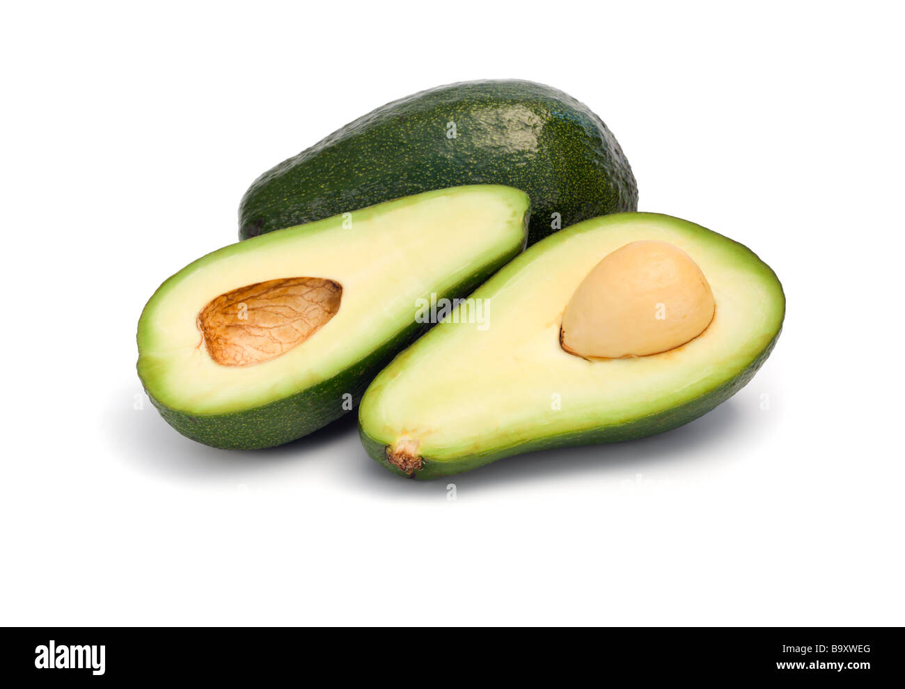 ganze und halbierte Avocado Frucht isoliert auf weiss Stockfoto
