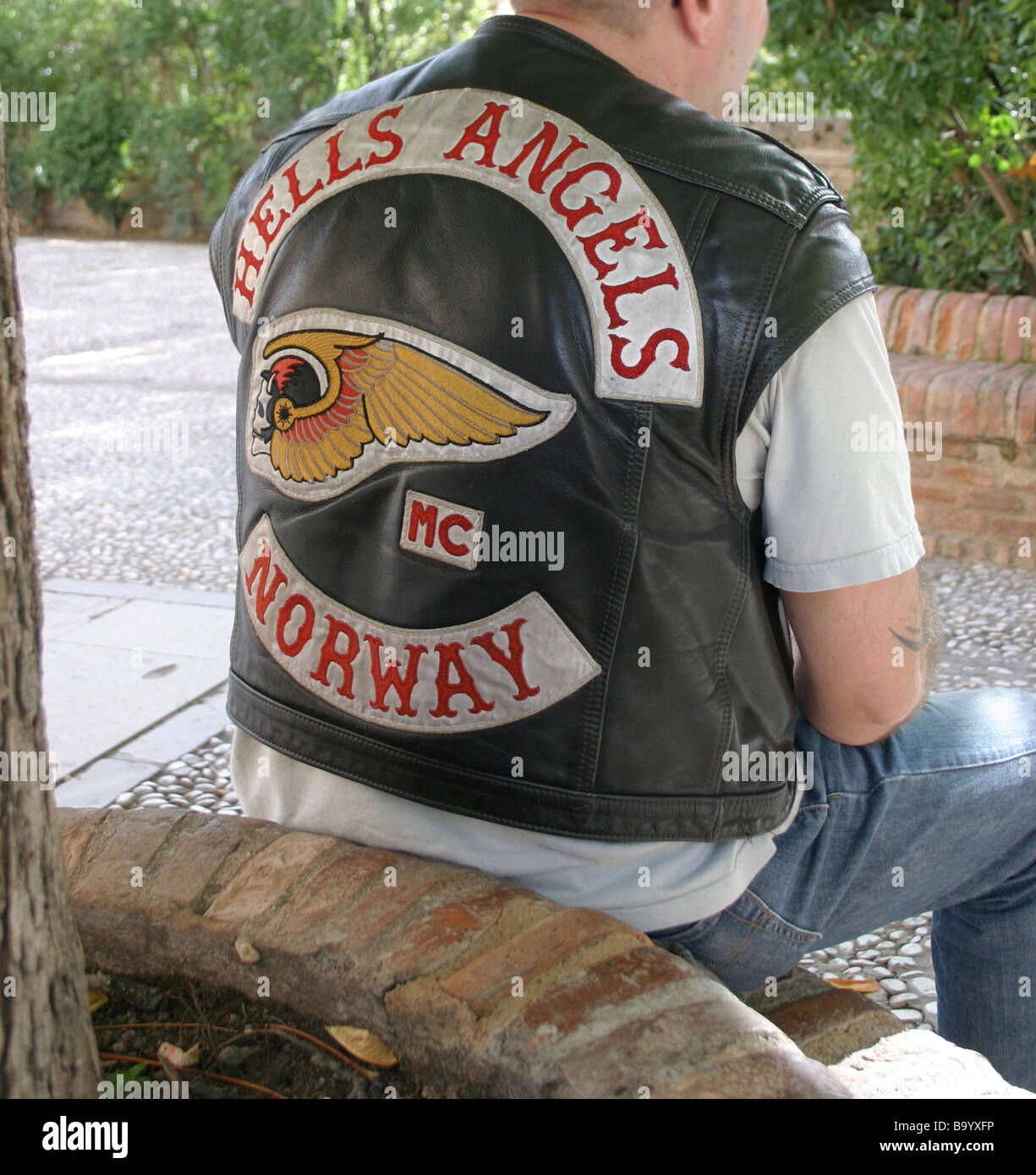 efter skole Happening tyktflydende Hells Angels Norwegen. Ein Mann in eine kurze Sleved-Leder-Biker-Jacke  sitzt auf einem Ziegel Pflanzer in den historischen spanischen Palast  Stockfotografie - Alamy