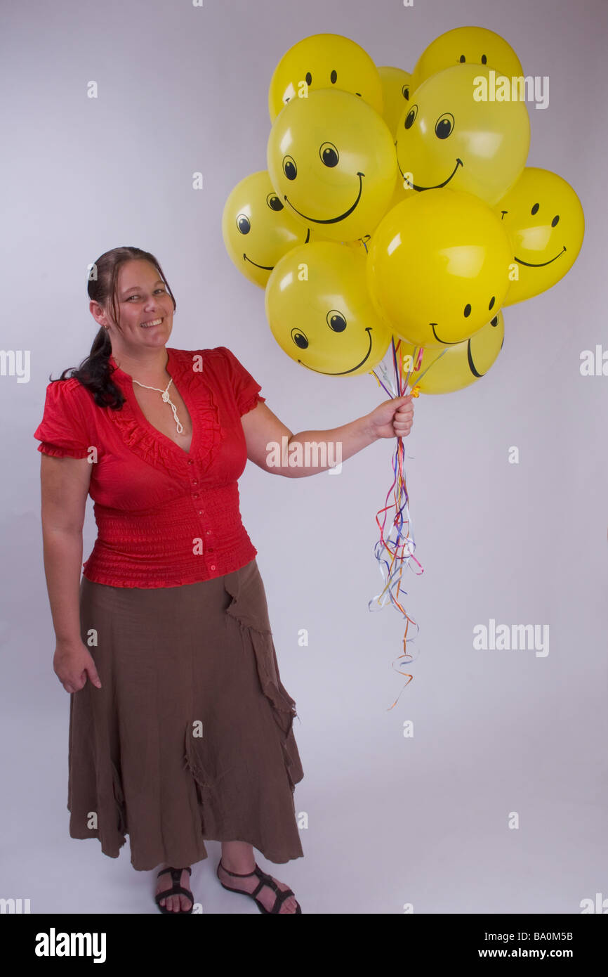 glückliche Frau mit Luftballons Stockfoto