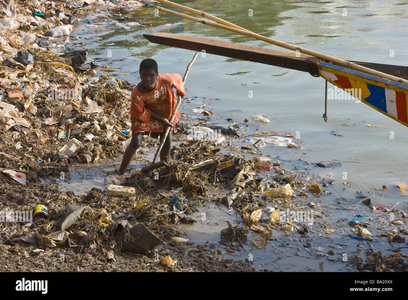 Junge Kommissionierung durch Müll im Hafen von Mopti Mali Stockfoto
