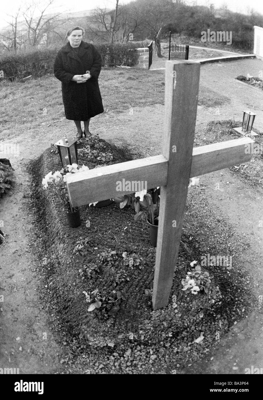 Der siebziger Jahre, schwarz / weiß Foto, Menschen, Tod, Trauer, Friedhof, ältere Frau steht auf einem Grab, im Alter von 60 bis 70 Jahren, Traut Stockfoto