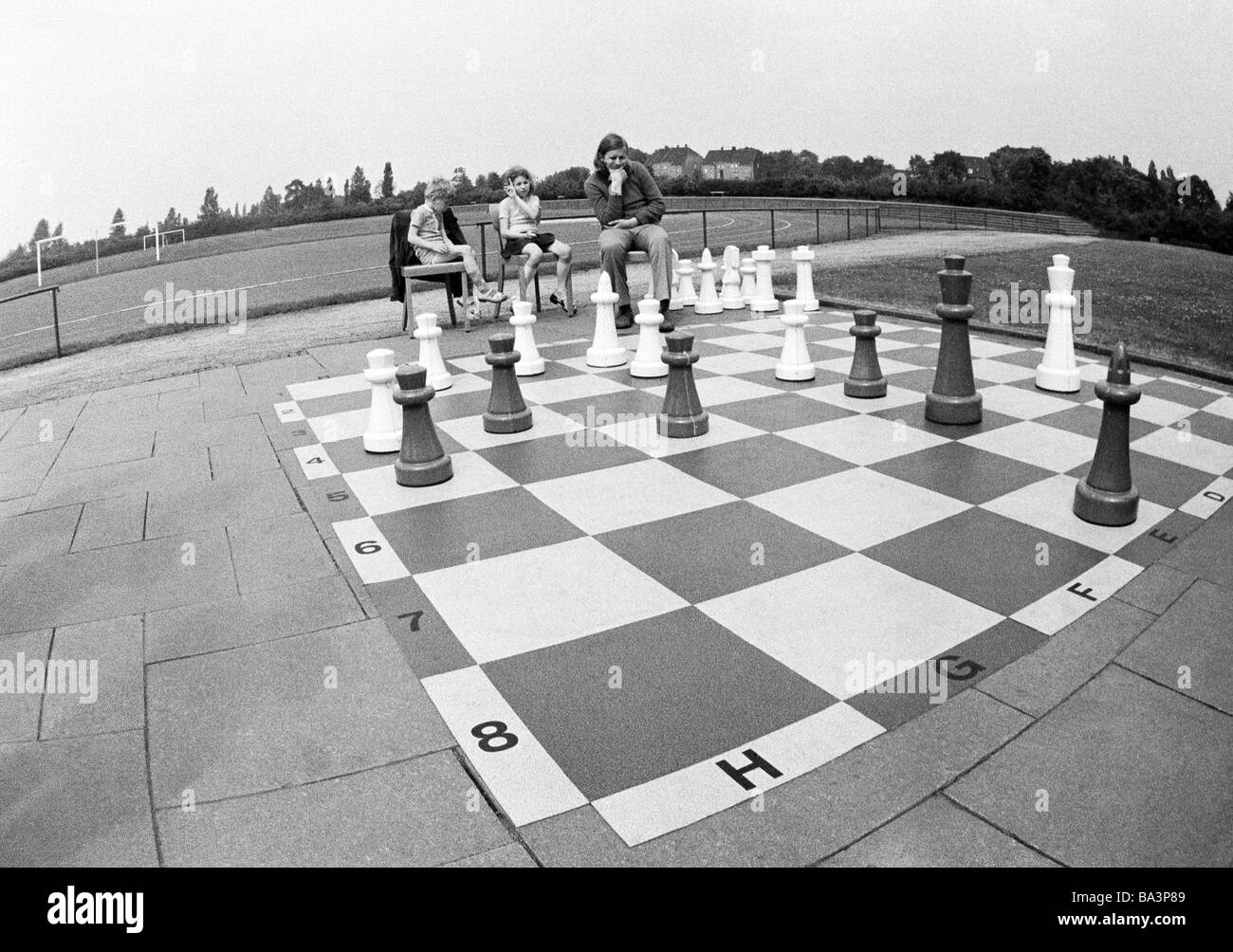 70er Jahre, schwarz / weiß Foto, Freizeit, Menschen spielen bei einem großen Freiluft-Schachspiel Stockfoto
