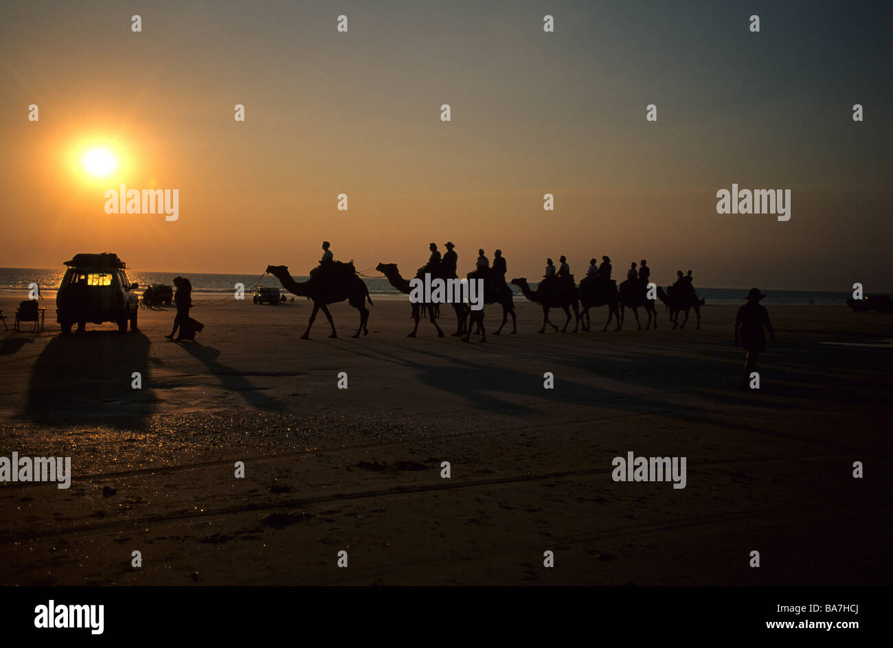Menschen Kamelreiten am berühmten Cable Beach bei Sonnenuntergang, Broome, Western Australia, Australien Stockfoto