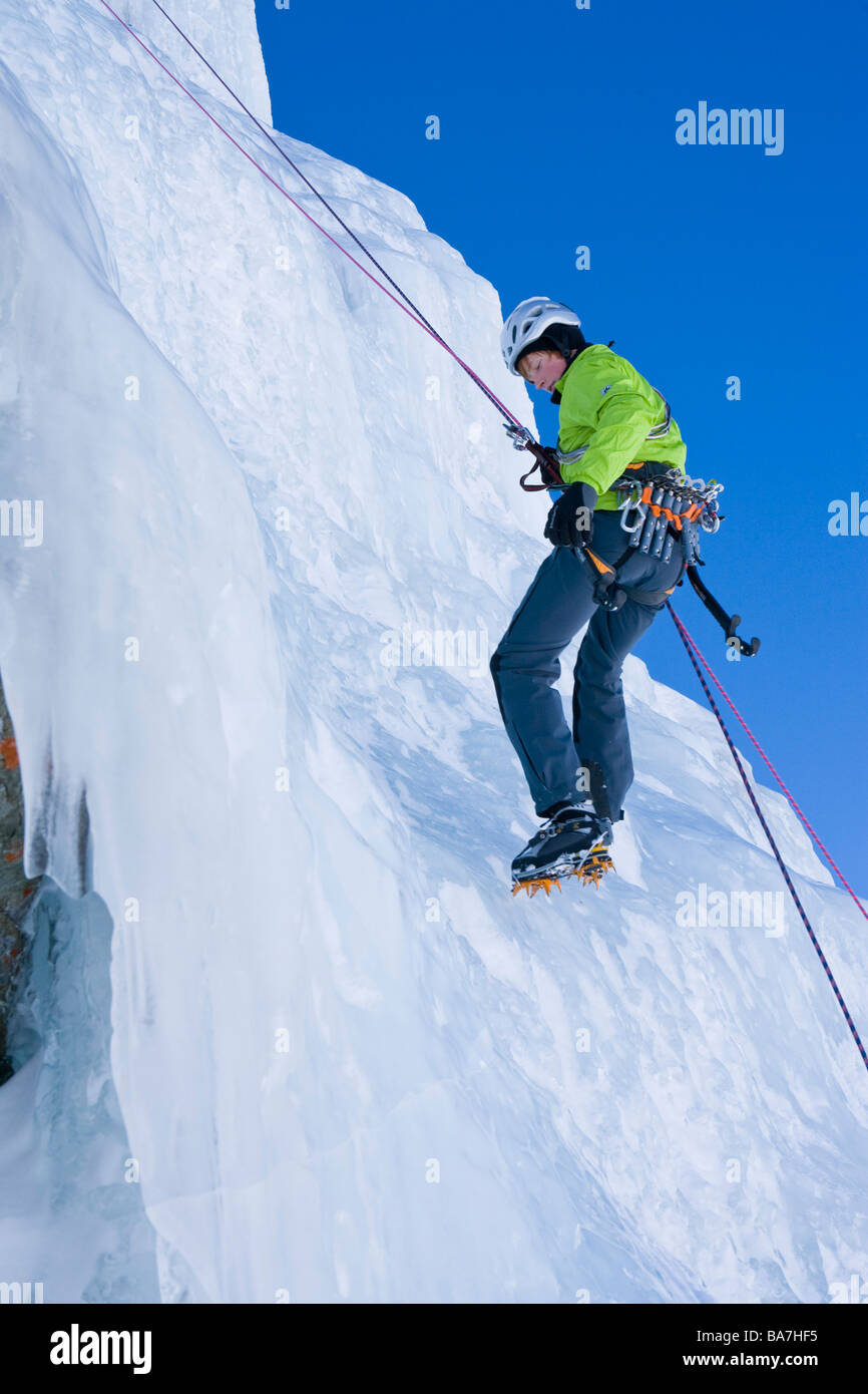 Ein Jung Mann, ein Eis-Kletterer Abseilen auf dem gefrorenen Wasserfall, Corn Diavolezza in Pontresina, Graubünden, Schweiz, Herr Stockfoto