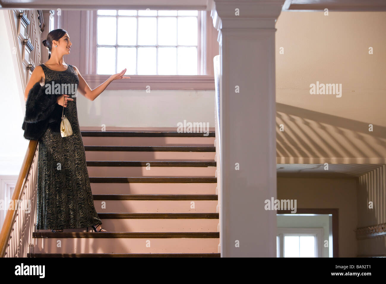 Hispanic Frau in formelle Gewand stehend auf der Treppe Stockfoto
