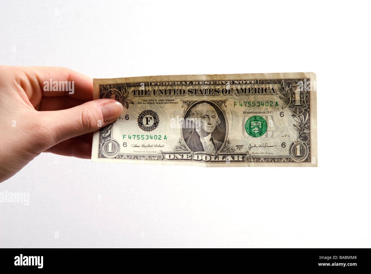 Frau Hand mit einer ein-Dollar-Banknote vor einem weißen Hintergrund Stockfoto