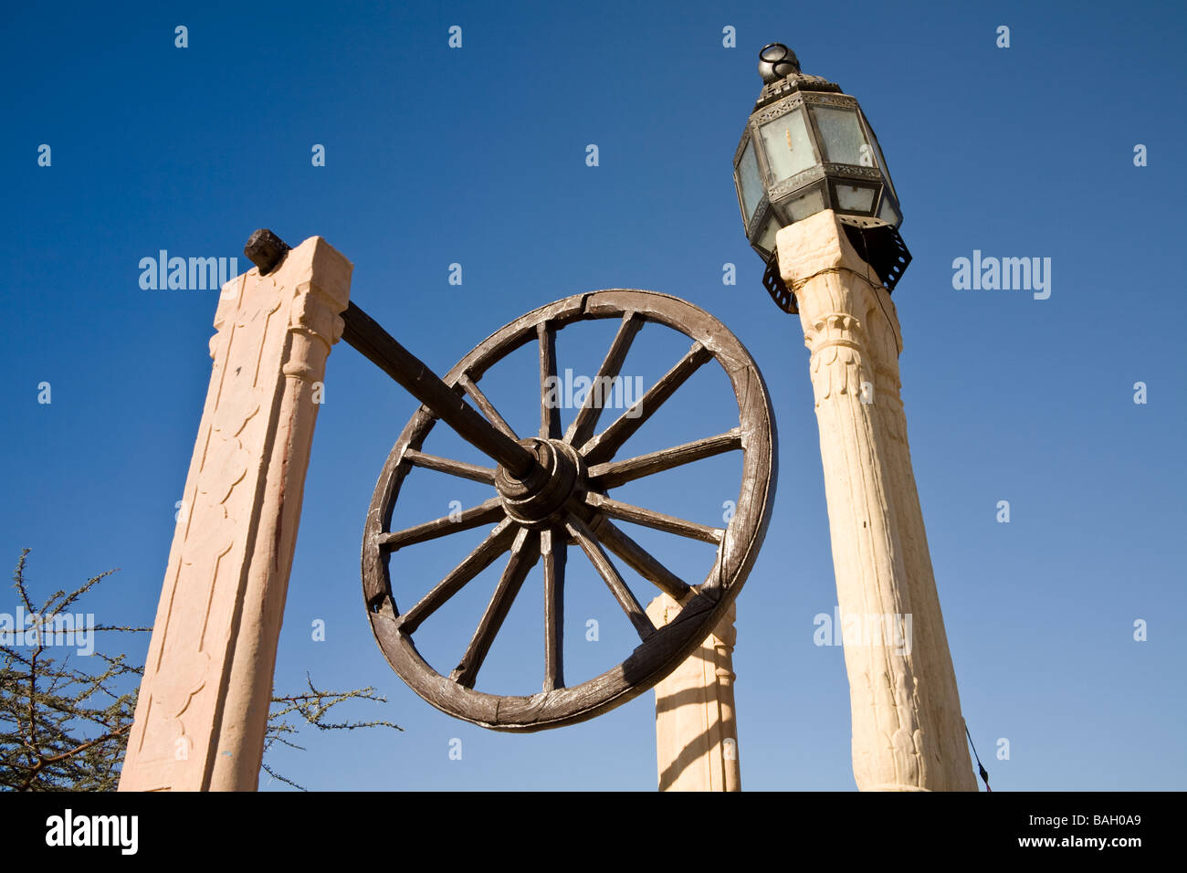 Ornamentale Rad und Laternenpfahl in die Gärten von Osian Camel Camp, Osian, Rajasthan, Indien Stockfoto
