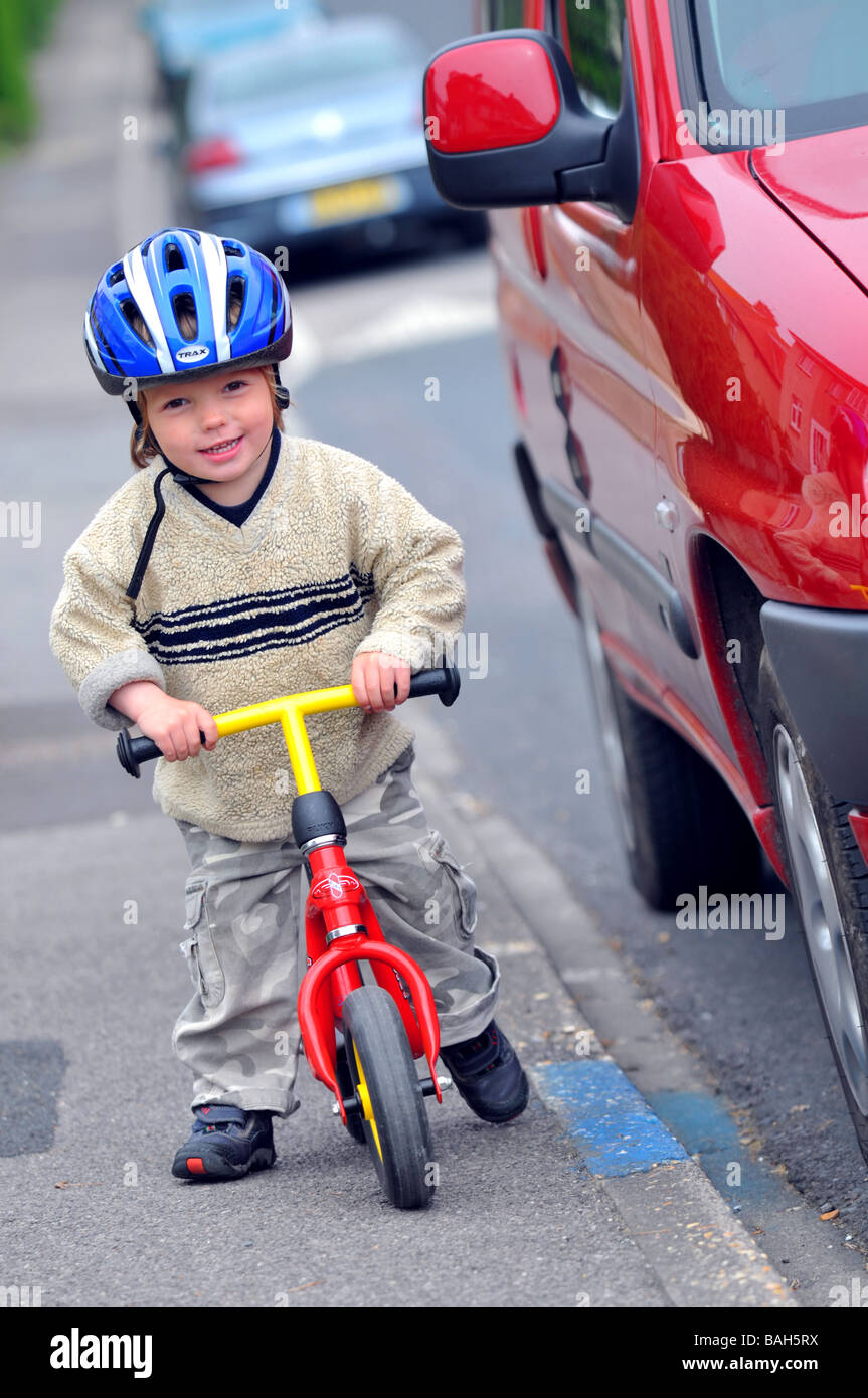 Junge mit dem Balance-Fahrrad fahren lernen Stockfoto
