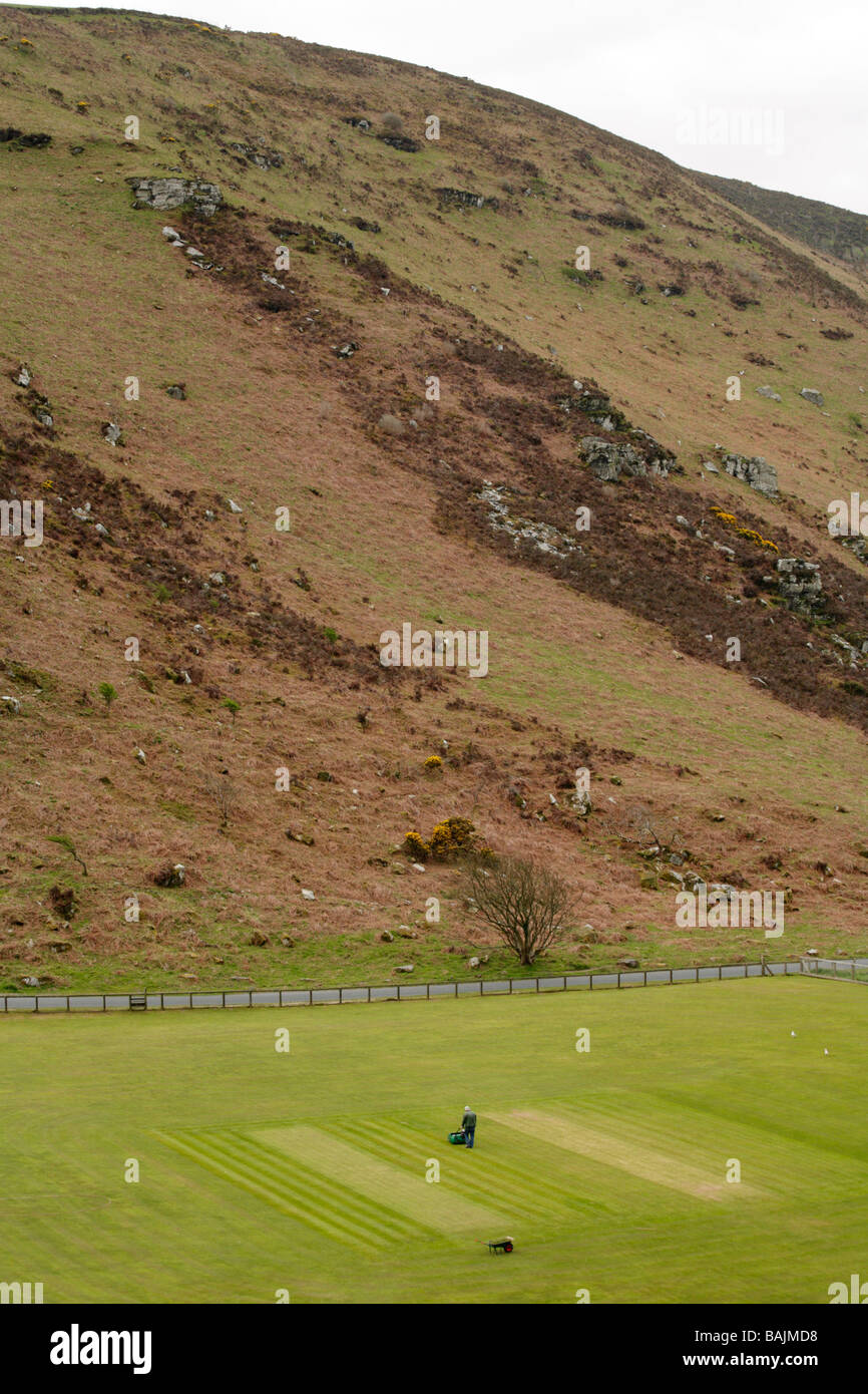 Platzwart Vorbereitung Cricket-Platz inmitten von Felsen und Hügeln im Tal der Felsen, Lynton, North Devon. Stockfoto