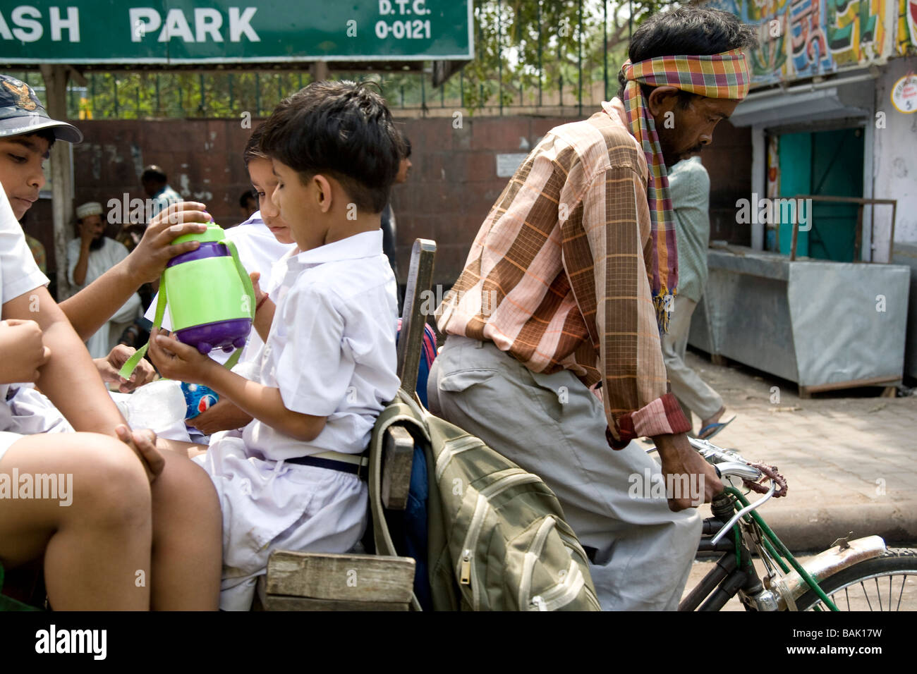 Indien-Delhi A Velo-Rikscha als einen "Schulbus" Stockfoto