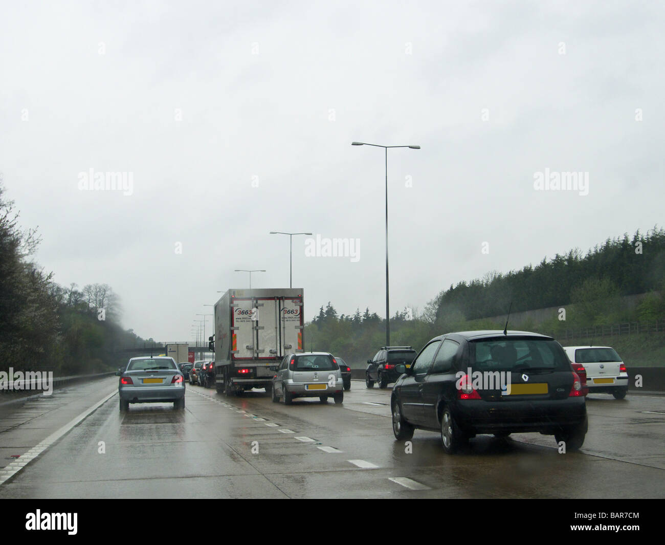 Warteschlangen Verkehr auf der Autobahn M25 in nassen Wetter, England Stockfoto