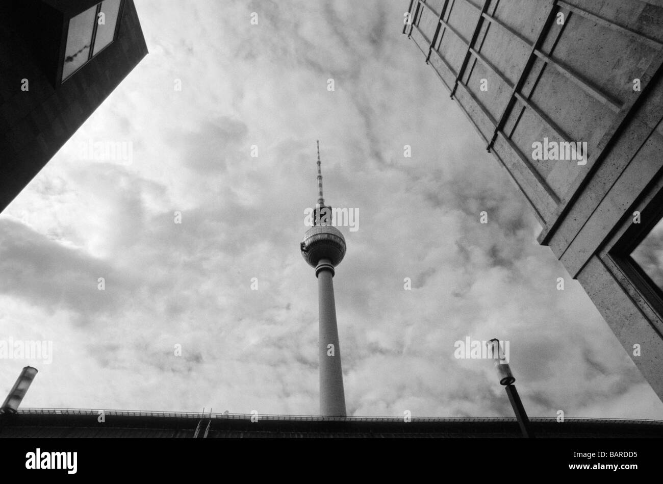 schwarz / weiß Foto von Fernsehturm und Gebäude am Alexanderplatz mit bedecktem Himmel Berlin Deutschland Stockfoto