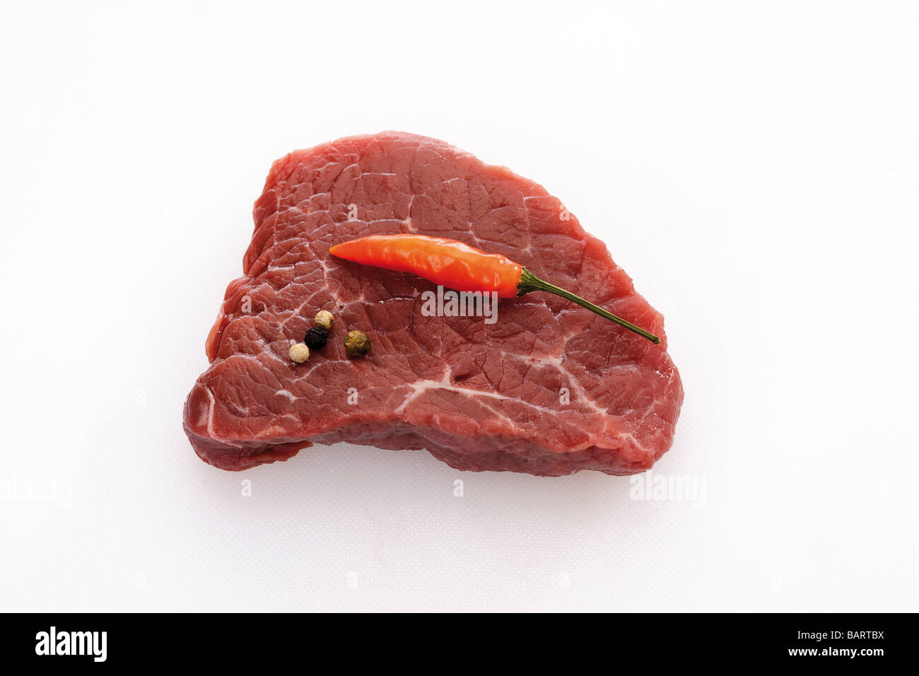 Rohes Steak, Pfefferkörnern und Chili Schote, erhöhten Blick Stockfoto