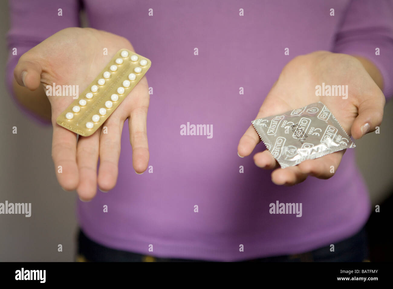 Frau mit Pille und Kondom Stockfoto
