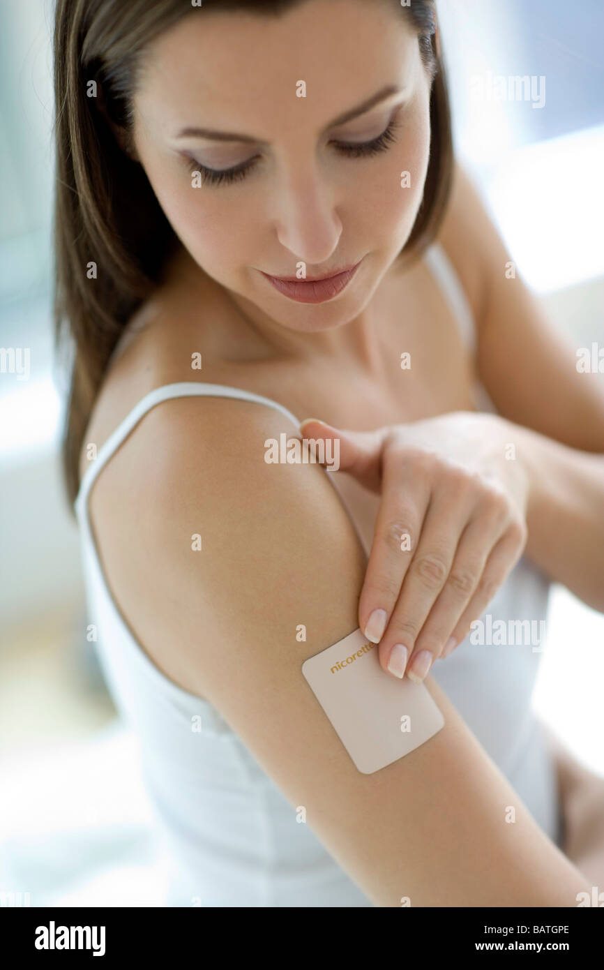 Nikotinpflaster auf eine Frau Arm. Nikotin ist eine süchtig machende Droge, die in Zigaretten gefunden. Stockfoto