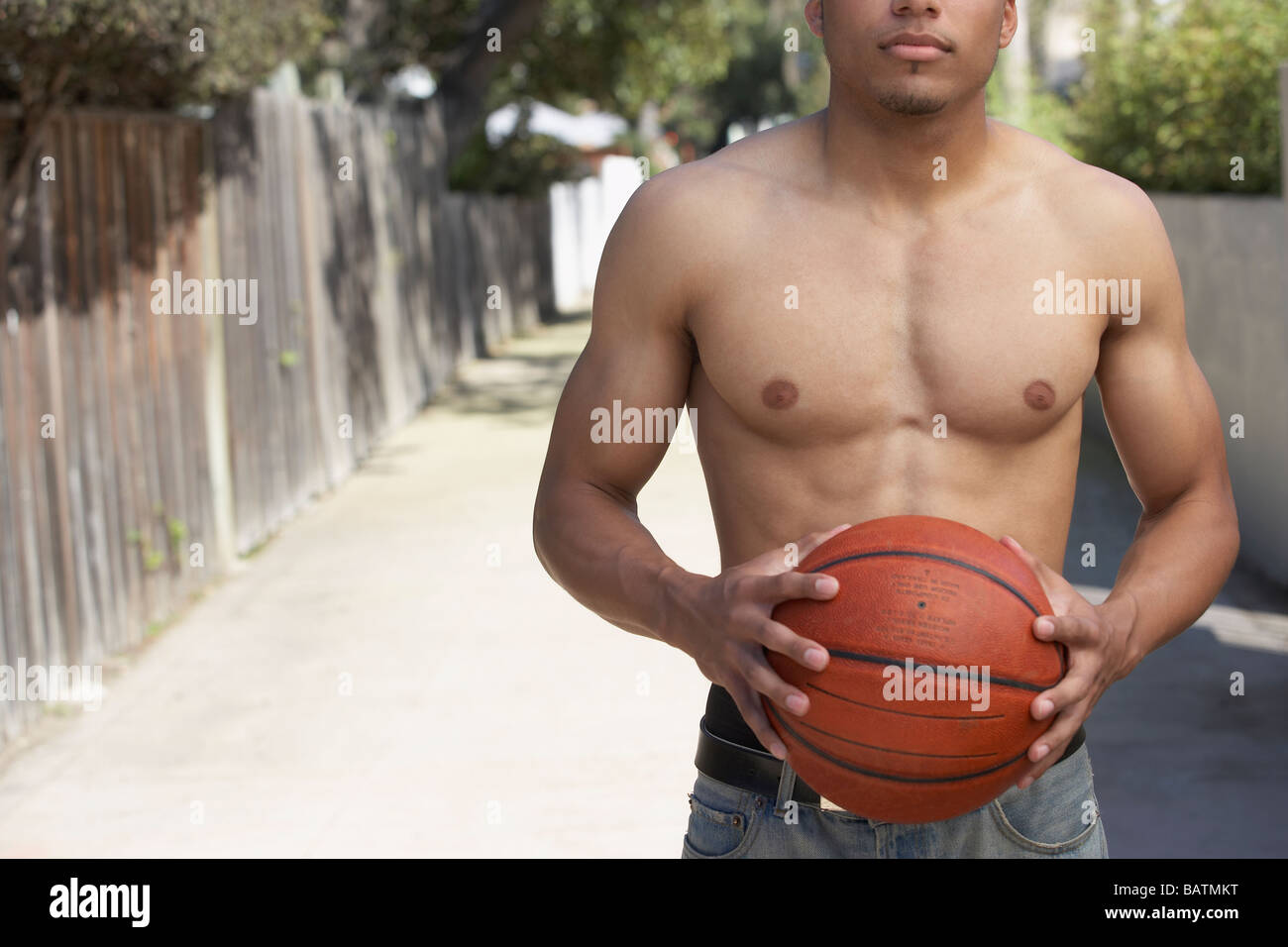 Junge gemischte Rennen Mann mit nacktem Oberkörper halten basketball Stockfoto