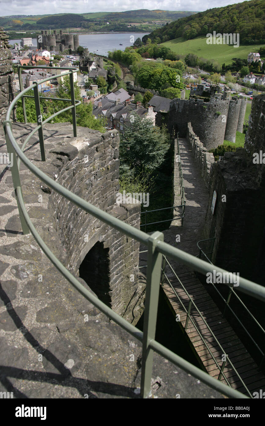 Stadt Conwy, Wales. Conwy Stadtmauer Gehweg mit Conwy Castle und der Fluss Conwy im Hintergrund. Stockfoto