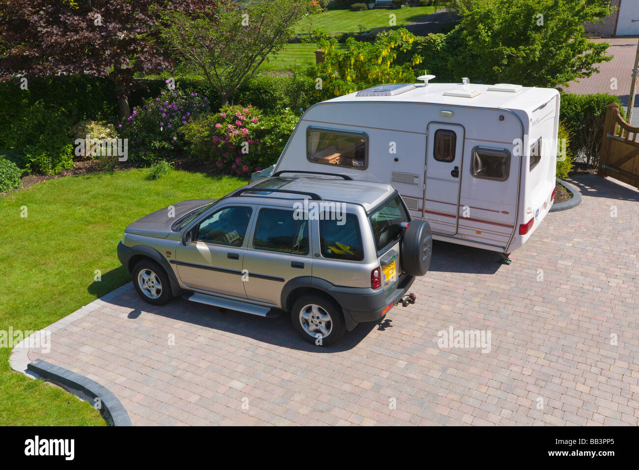 Auto und Wohnwagen geparkt auf Einfahrt eines Hauses Stockfoto