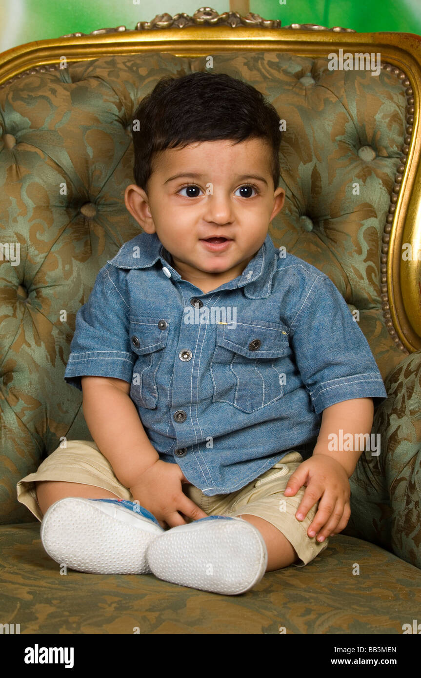 Kleine 6 Monate alte arabische Jungen sitzen auf dem Sofa Stockfoto