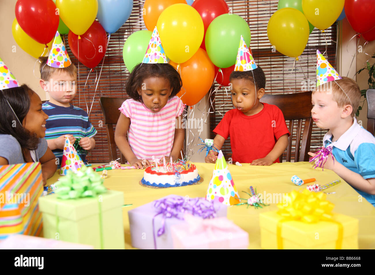 Junges Mädchen Ausblasen der Kerzen auf Geburtstagsparty Stockfoto