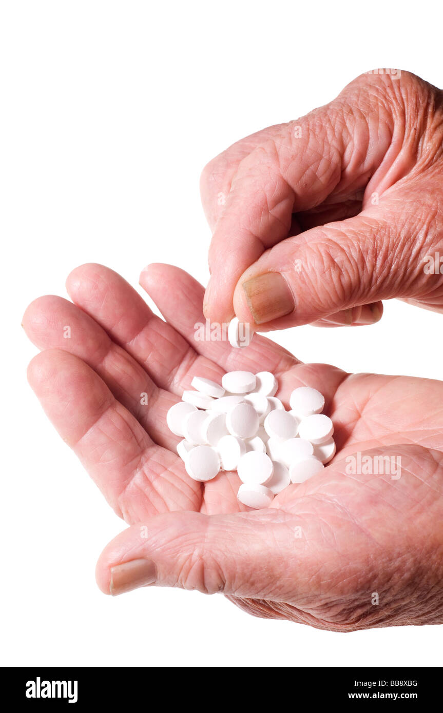 Leitenden Händen mit Haufen von Tabletten Stockfoto