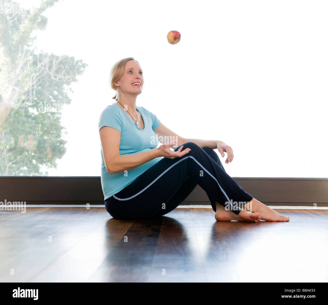 Schwangere Frau Jonglage Apfel Stockfoto