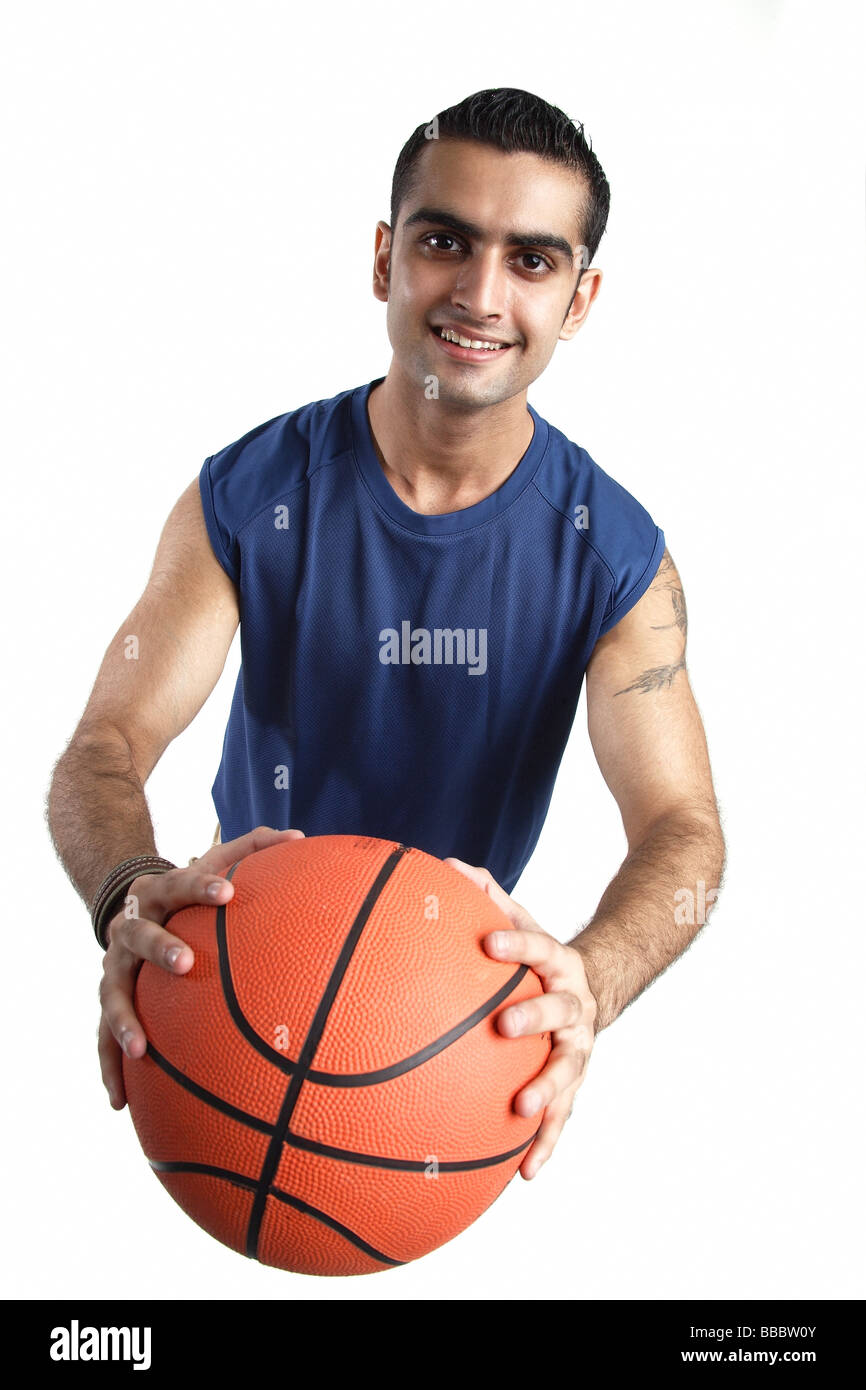 Junger Mann Betrieb Basketball, Blick in die Kamera Stockfoto