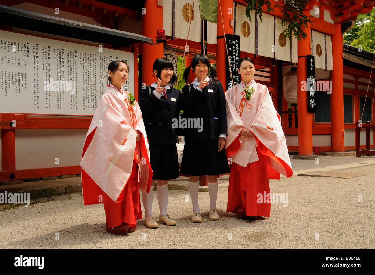 Japanische Studenten in Uniform mit dem Schrein Jungfrauen als ein Fotomotiv mit der typisch japanischen Victory-Zeichen, Shimogamo shri Stockfoto