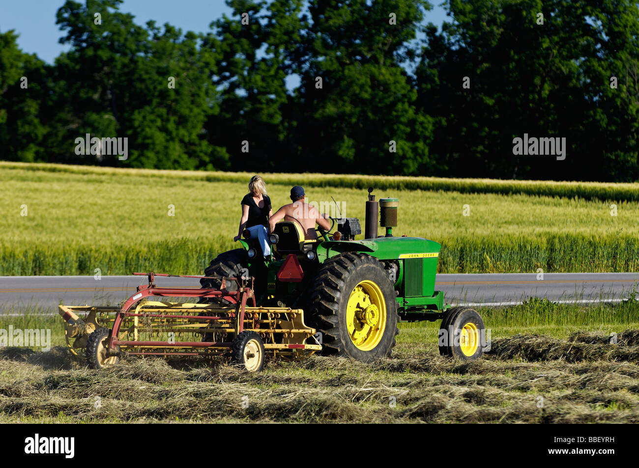 Bauer und seine Frau auf John Deere 3010 Diesel-Traktor im Harrison County Indiana Stockfoto