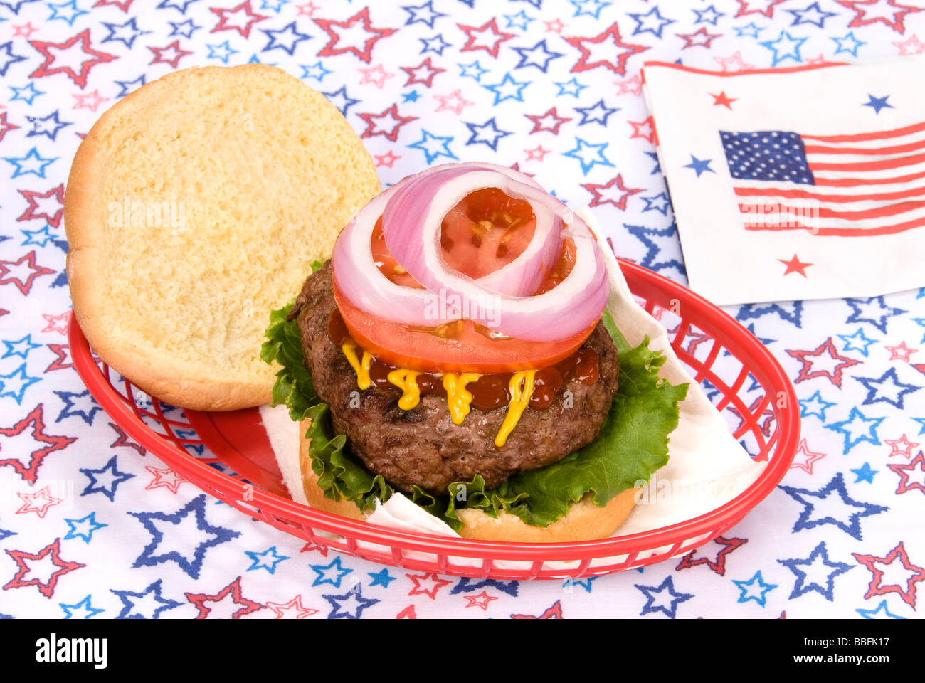 Einen dicken saftigen Hamburger in einem Korb mit einem vierten Juli Thema Stockfoto