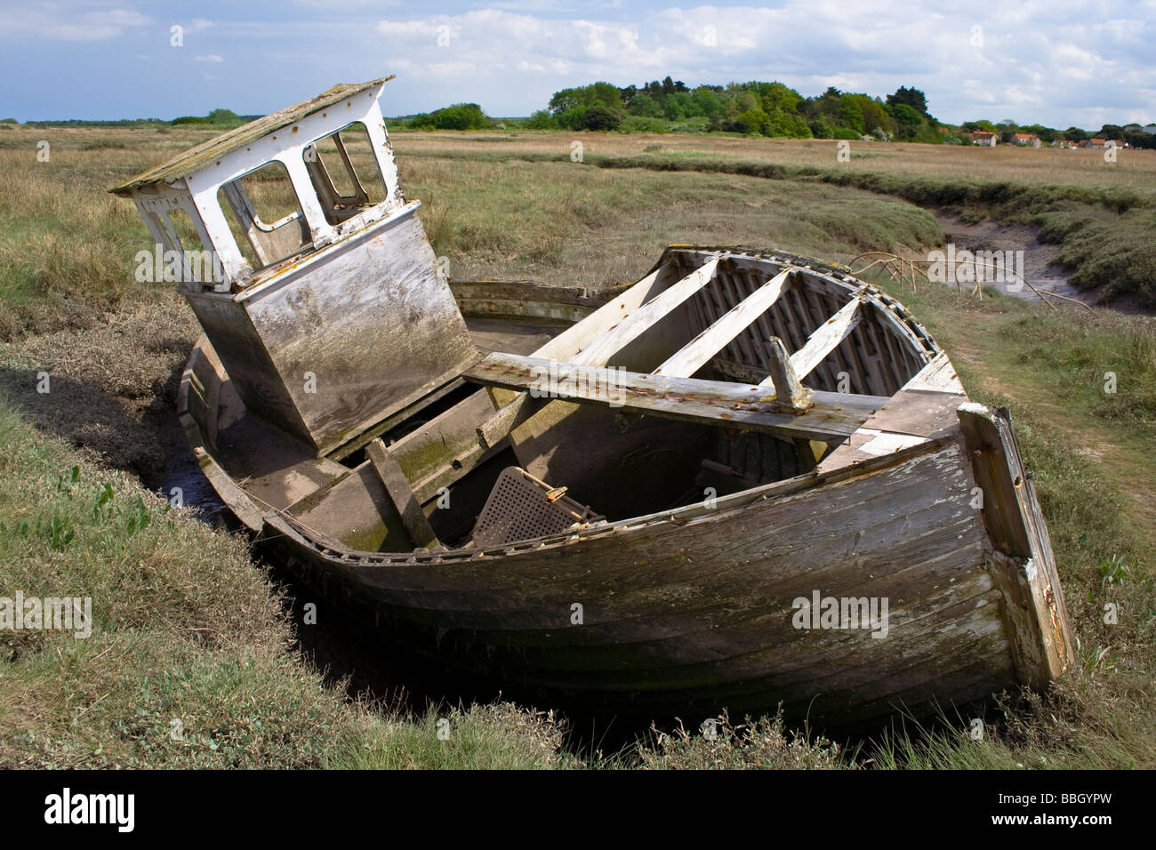 Eine zerstörte Fischerboot liegen im Schlamm auf die Sümpfe an der nördlichen Küste von Norfolk Stockfoto