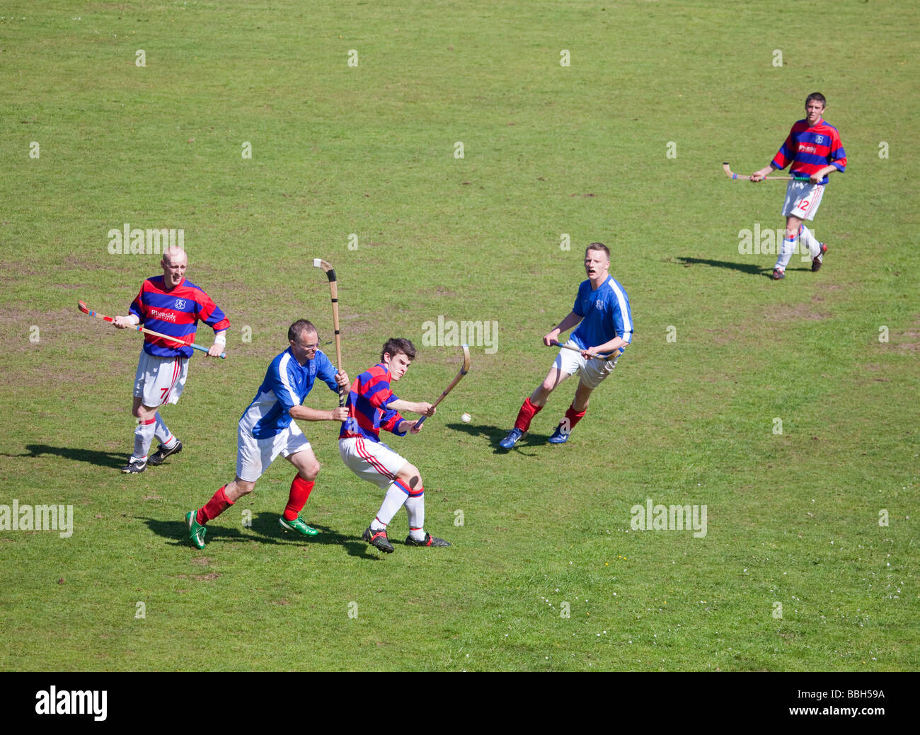 Ein Tackling während eines Spiels von Shinty zwischen Kyles, sportliche Tighnabruaich und Kingussie Camanachd. Stockfoto