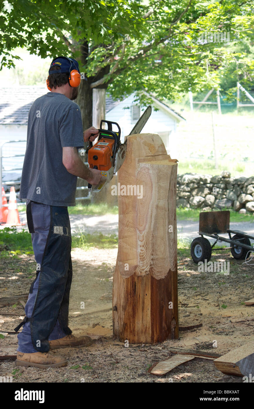 Mann mit Kettensäge schnitzen Figur aus einem Stück Zeder Stockfoto